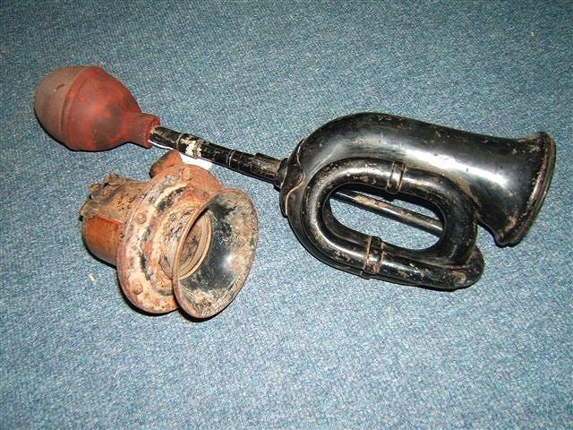 Appraisal: A BLACK PAINTED CAR HORN with red rubber bulb and