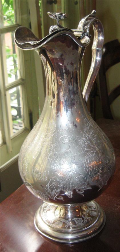 Appraisal: Silverplate ewer with flower finial and grapevine engravingearly th century