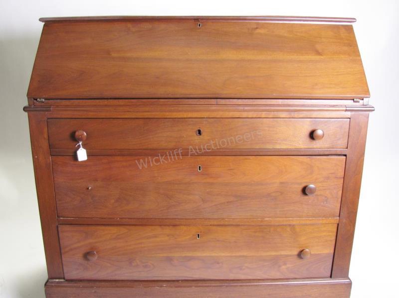 Appraisal: An antique desk-secretary with slant front revealing fitted interior with