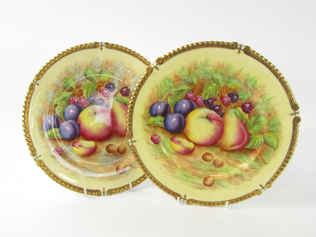 Appraisal: A pair of Aynsley porcelain plates with gadrooned rims painted