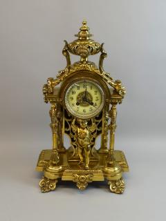 Appraisal: Brass mantel clock with central putti holding up the clock