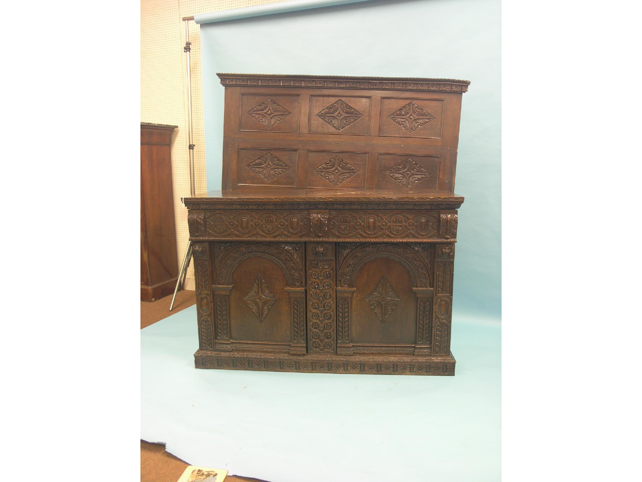 Appraisal: A th century-style oak sideboard raised panel-back above single ash-lined