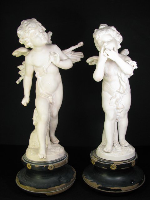 Appraisal: Pair th century bisque cherubs mounted on painted black wood