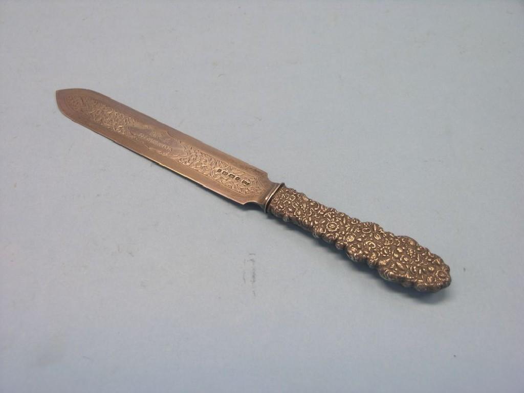 Appraisal: A Victorian silver bread knife with embossed handle and engraved