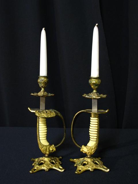 Appraisal: UNUSUAL VICTORIAN SWORD HILT CANDLESTICKS The pair fashioned from lion's