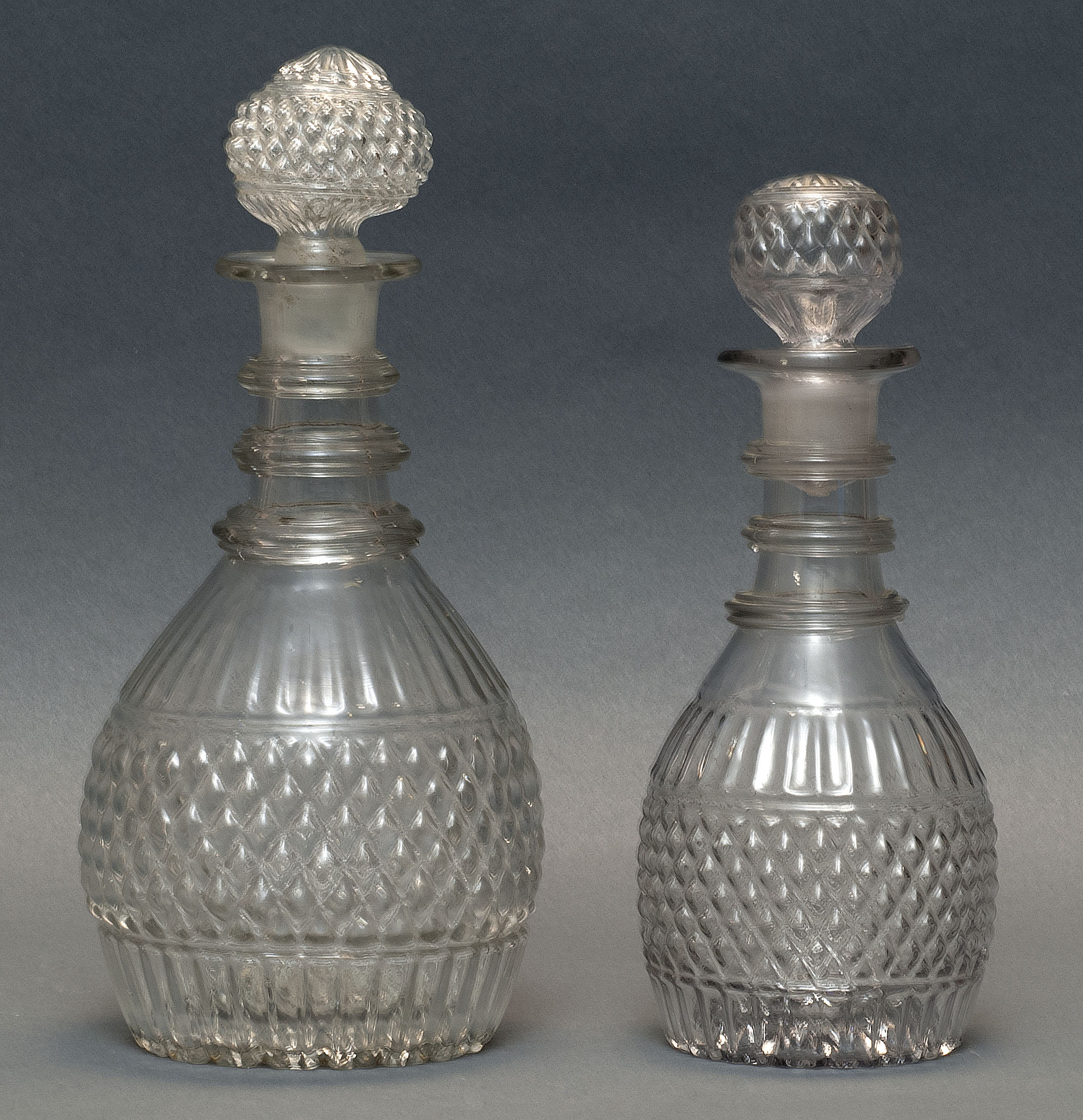 Appraisal: TWO CLEAR GLASS BLOWN -MOLD DECANTERS Second Quarter of the