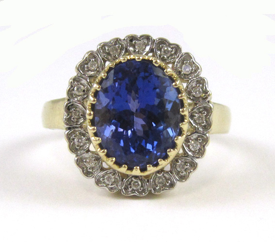 Appraisal: TANZANITE DIAMOND AND FOURTEEN KARAT GOLD RING with round-cut diamonds