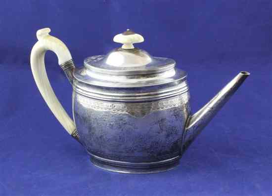 Appraisal: A George III silver oval teapot with engraved foliate swag