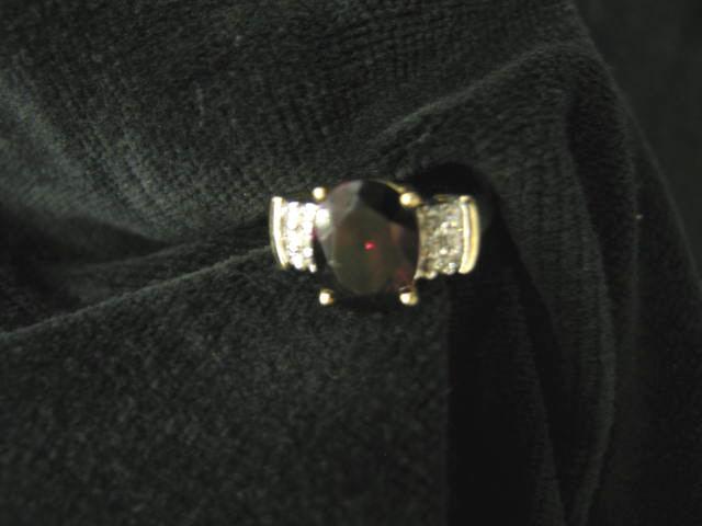 Appraisal: Garnet Diamond Ring rich oval gem with six diamonds on