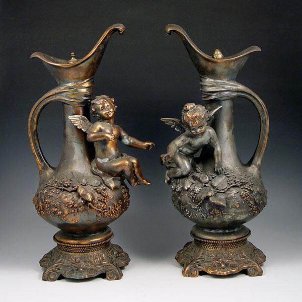 Appraisal: PAIR VICTORIAN CUPID FIGURAL URNS Decorative urns with a cupid