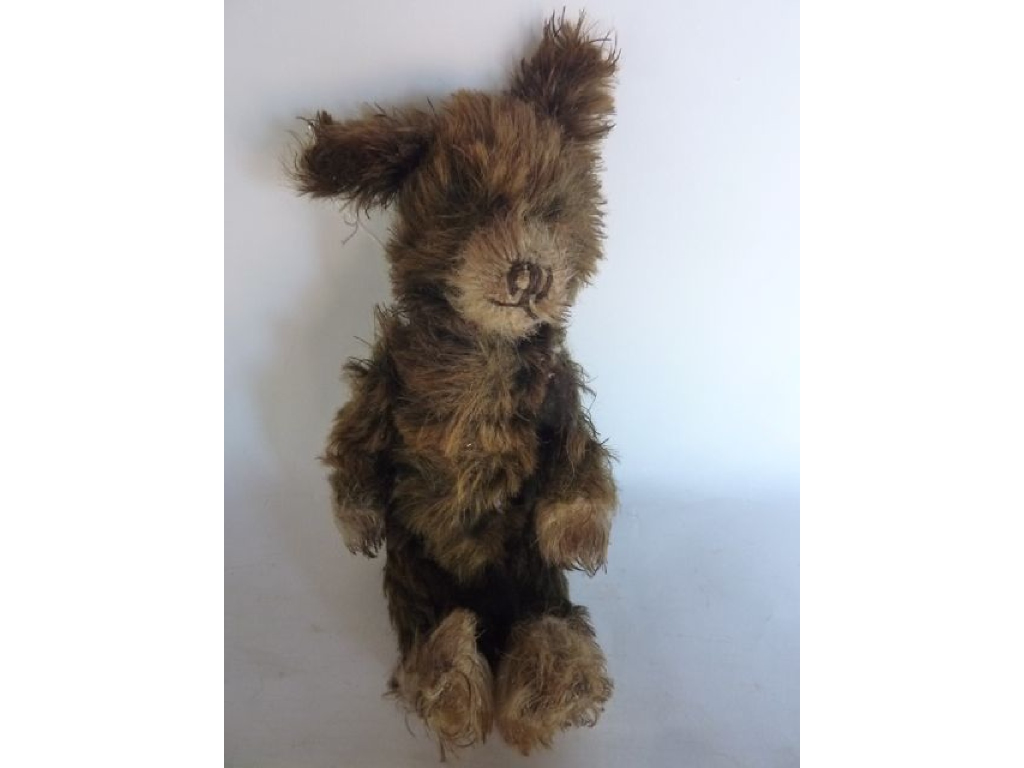 Appraisal: A small vintage teddy bear with brown fur and jointed