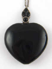 Appraisal: A white metal tests silver mounted heart pendant approx cm