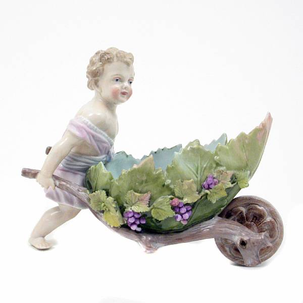 Appraisal: A German porcelain figure of a cupid pushing a wheelbarrow