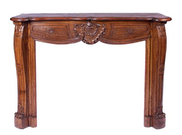 Appraisal: A French Rococo style carved oak fireplace mantel height in