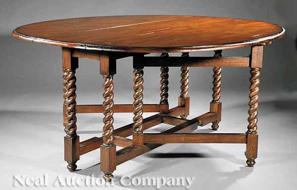 Appraisal: A Jacobean-Style Walnut Dining Table th c the top with