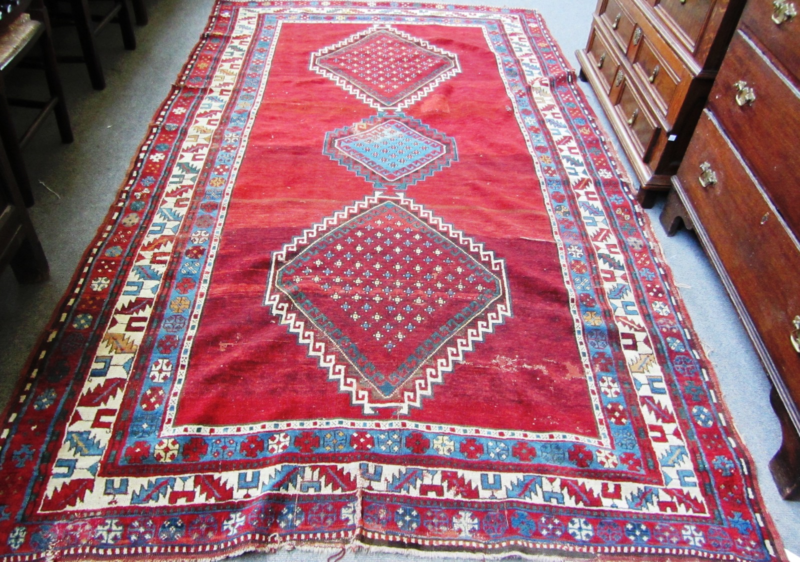 Appraisal: A Kazakh rug Caucasian the plain madder field with an