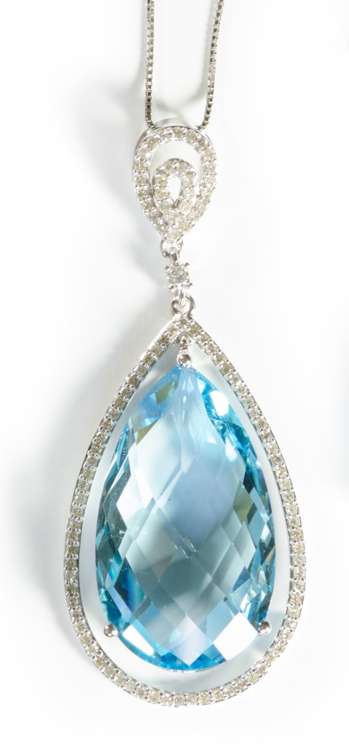 Appraisal: BLUE TOPAZ AND DIAMOND PENDANT NECKLACE suspended on a inch