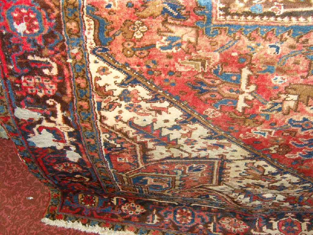 Appraisal: An eastern wool carpet with red cream and blue geometric