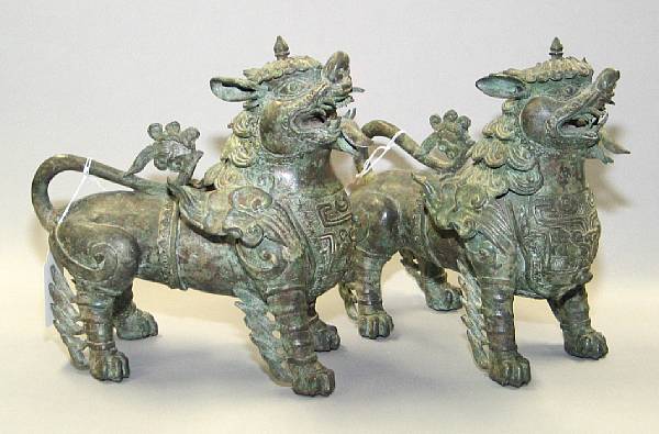 Appraisal: A pair of Himalayan patinated metal temple lions With Chinese