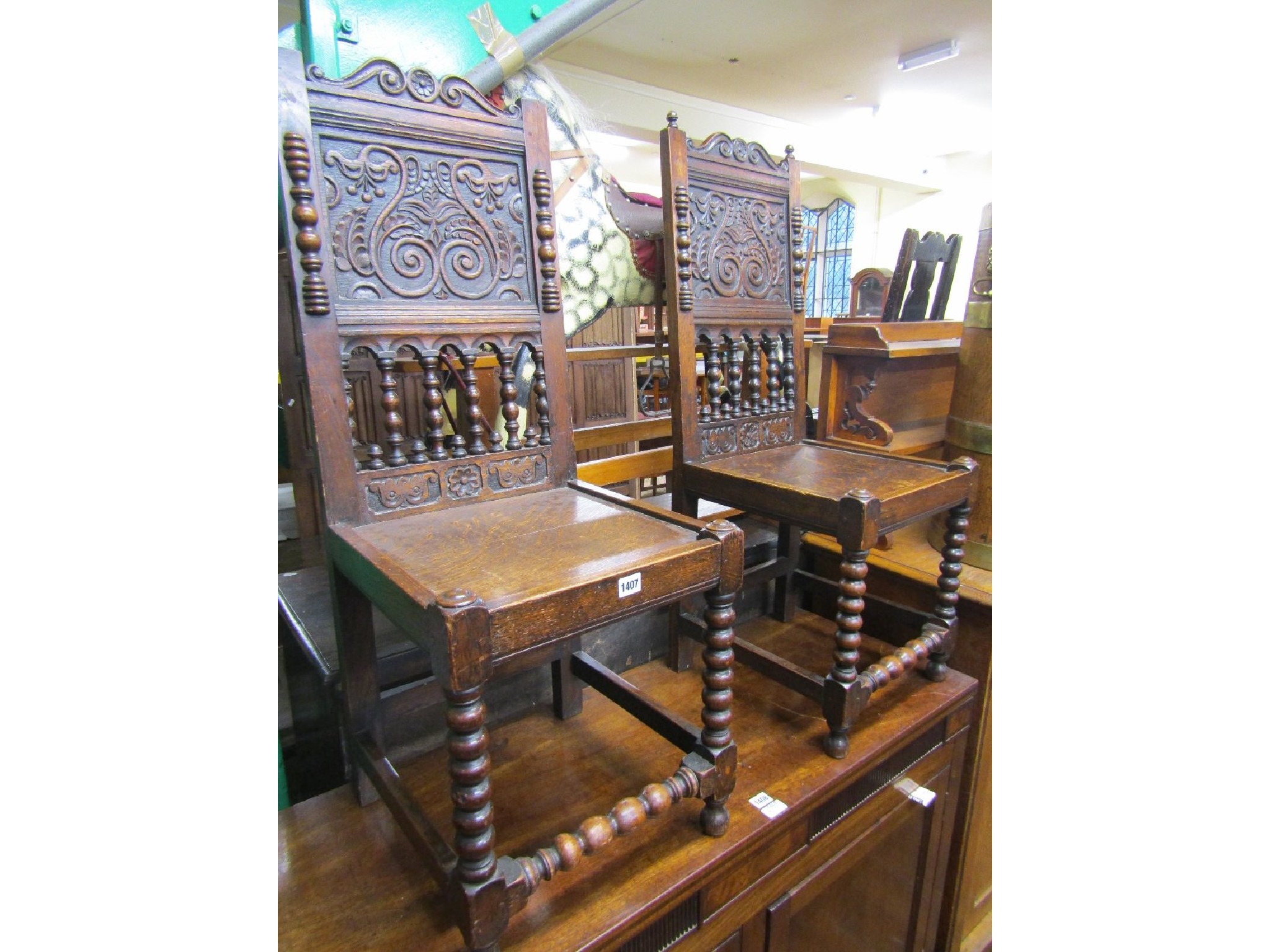 Appraisal: A pair of Victorian carved oak side or hall chairs