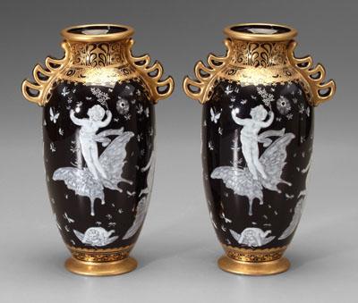 Appraisal: Pair porcelain vases cherubs riding butterflies on black ground gilt