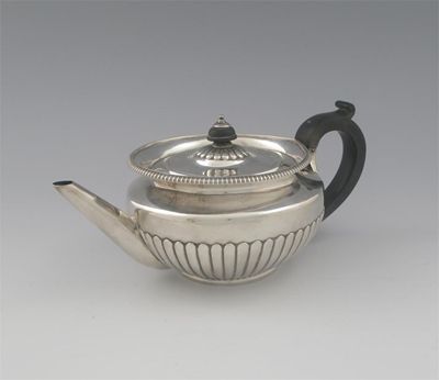 Appraisal: A George III teapot squat circular with a gadrooned rim