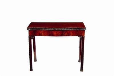 Appraisal: A George III carved mahogany serpentine card table retailed by