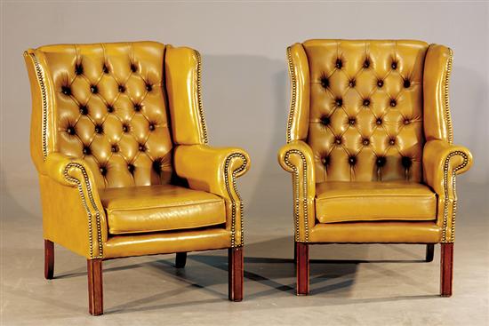 Appraisal: Pair Georgian style mahogany and leather wing chairs th centurytufted