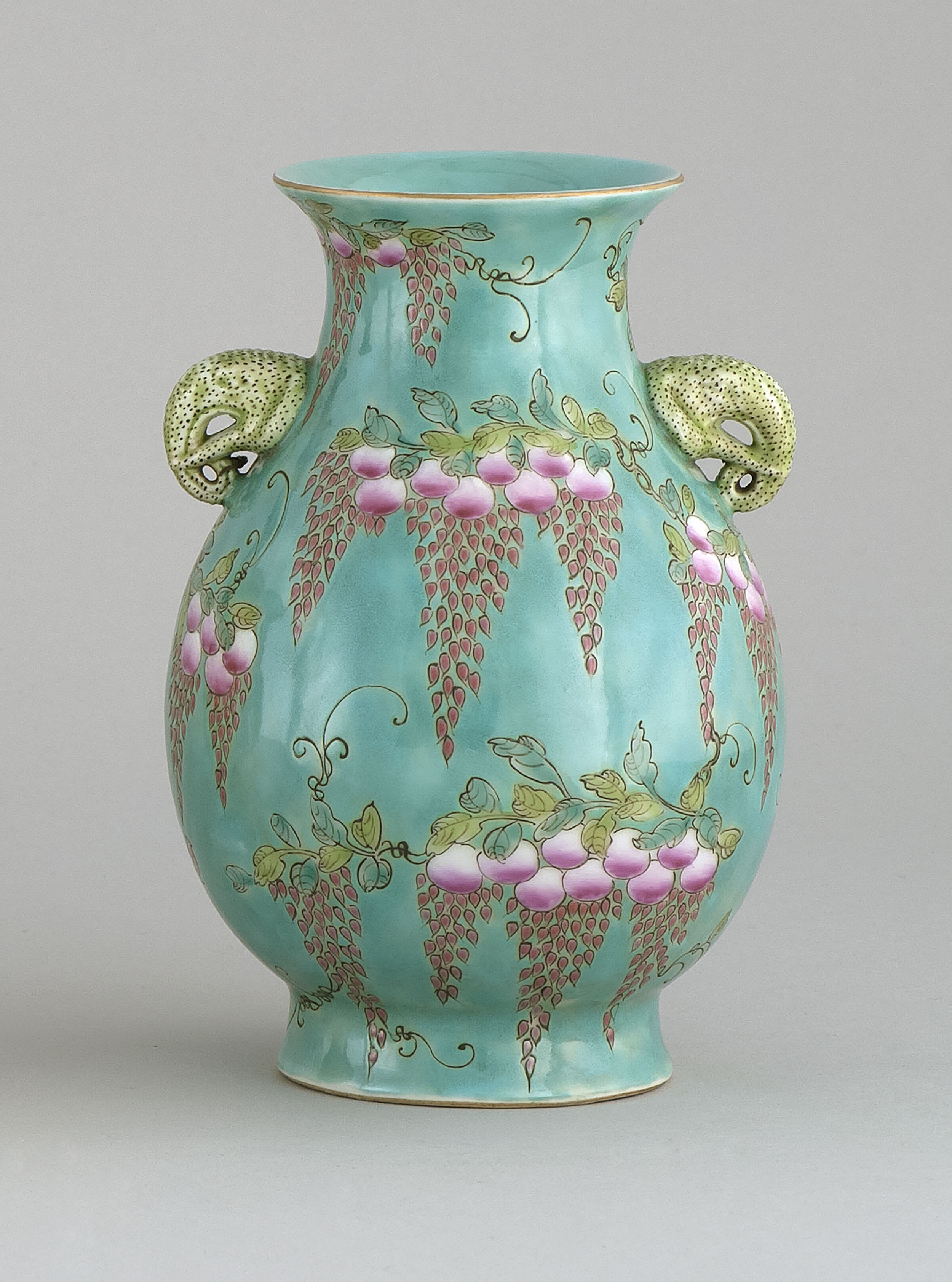 Appraisal: POLYCHROME PORCELAIN VASE In pear shape with elephant's-head handles and