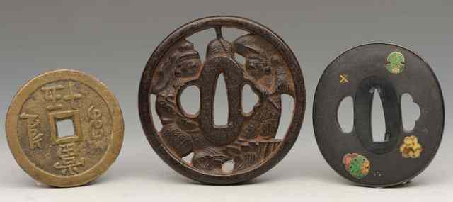 Appraisal: A JAPANESE TSUBA Shakudo overlaid cloisonne floral mons on nanako