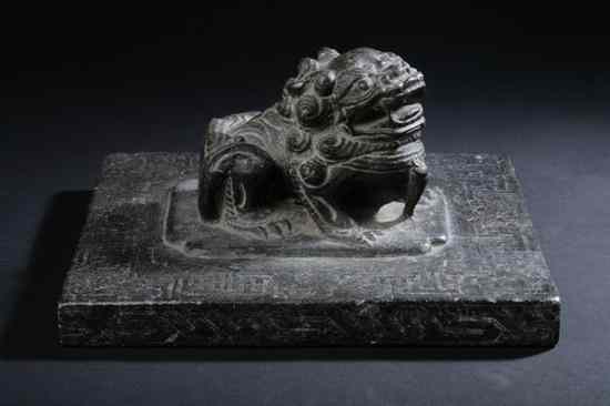 Appraisal: CHINESE BLACK LIMESTONE FU LION WEIGHT th th century Carved