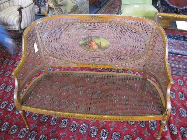 Appraisal: French Victorian Painted Fruitwood Caneloveseat courting scene medallion ribbon floral