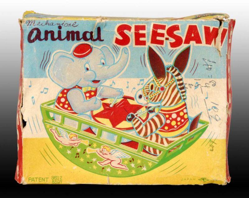 Appraisal: Japanese Tin Wind-Up Animal See-Saw Toy Description Includes original box