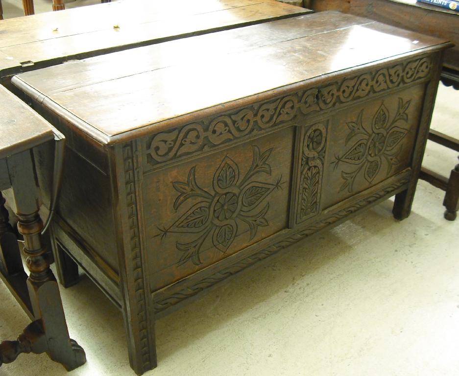 Appraisal: th century oak coffer the moulded lid over a foliate