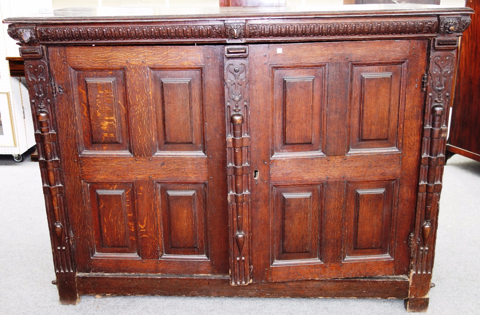 Appraisal: An oak cupboard incorporating th century elements carved frieze with