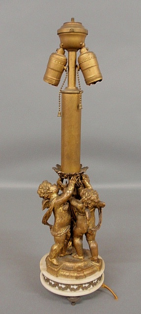 Appraisal: - Gilt metal putti table lamp c with a marble