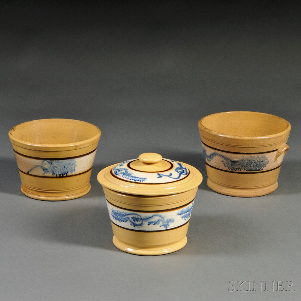 Appraisal: Three Yellowware Storage Containers with Blue Mocha Decoration North America