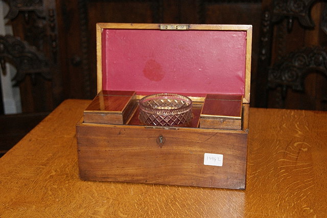 Appraisal: George III mahogany tea caddywith original cut glass mixing bowl