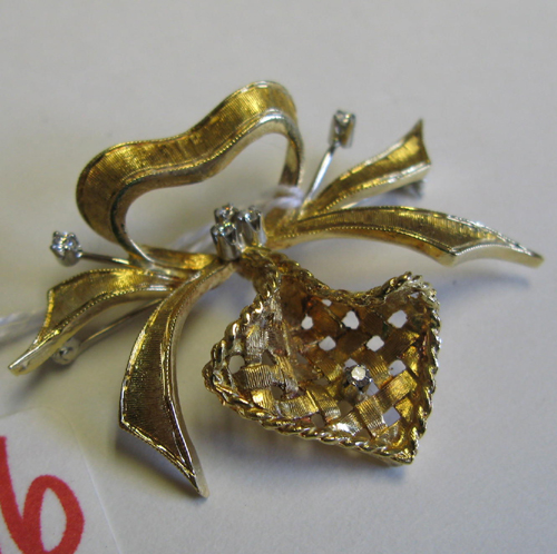 Appraisal: DIAMOND AND EIGHTEEN KARAT GOLD BROOCH of tied ribbon bow