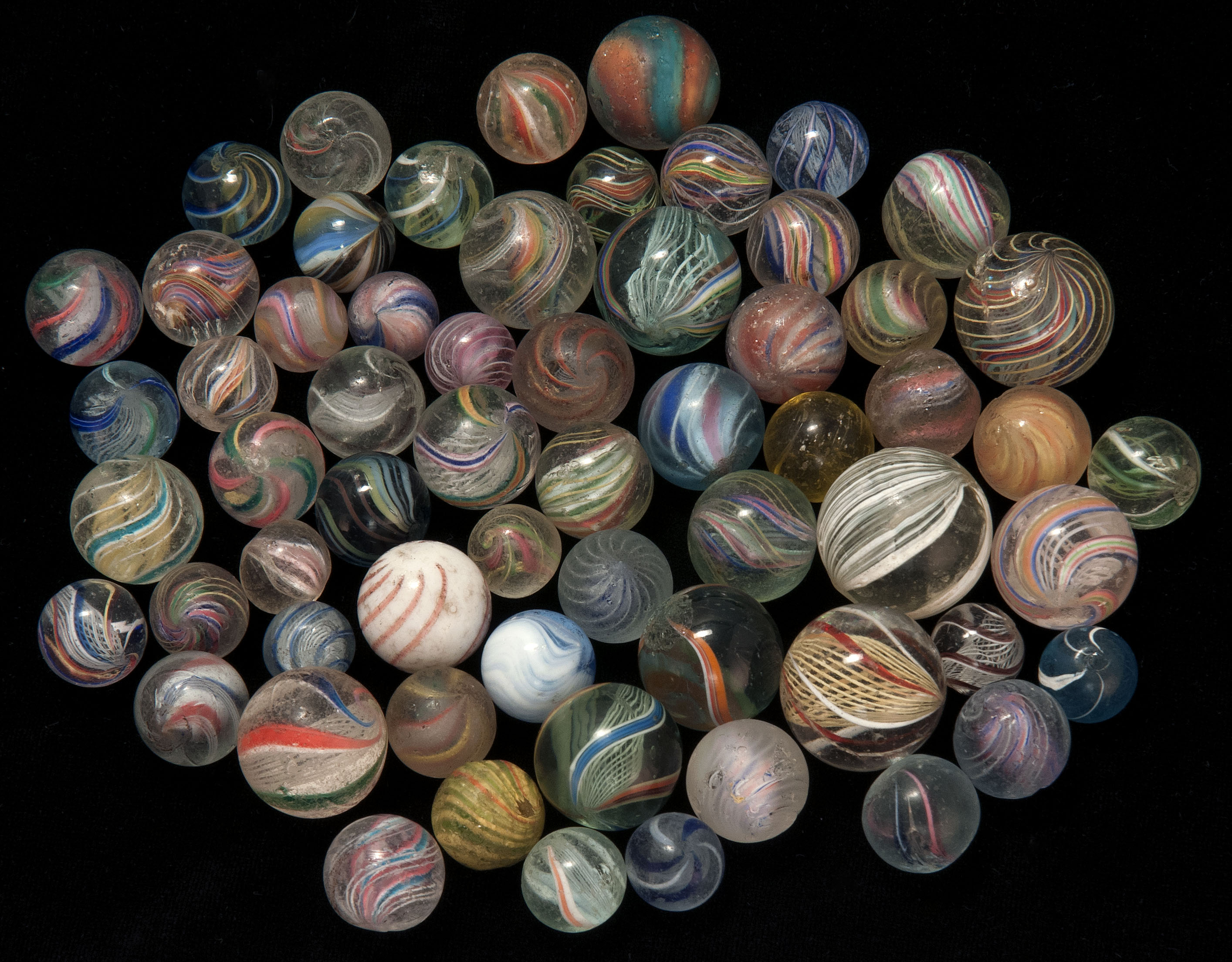 Appraisal: APPROXIMATELY FIFTY SWIRL GLASS MARBLES Sizes vary ConditionSome wear