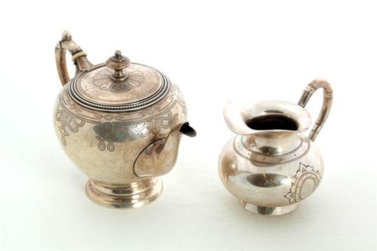 Appraisal: ENGRAVED SILVER TEAPOT AND CREAMER Netherlands Both marked for fineness