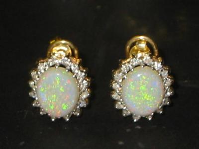 Appraisal: A PAIR OF OPAL AND DIAMOND CLUSTER EARRINGS the oval