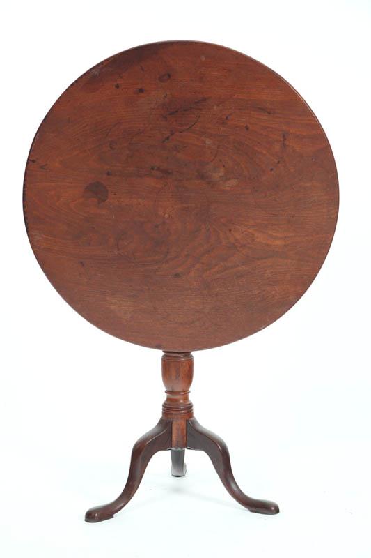 Appraisal: TILT TOP TABLE Walnut having a circular top turned standard