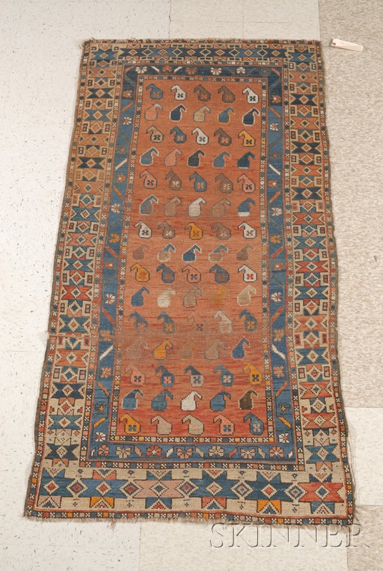 Appraisal: Caucasian Rug with brick red ground overall multicolored paisley field