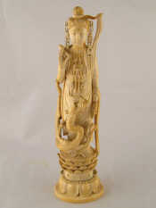 Appraisal: A th c Chinese ivory figure of Guanyin her right