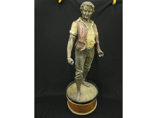 Appraisal: Early Metal Statue of a Young Man on drum tall