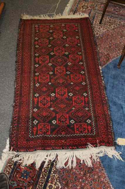 Appraisal: A PAKISTAN RED GROUND WOOL RUG x and one other