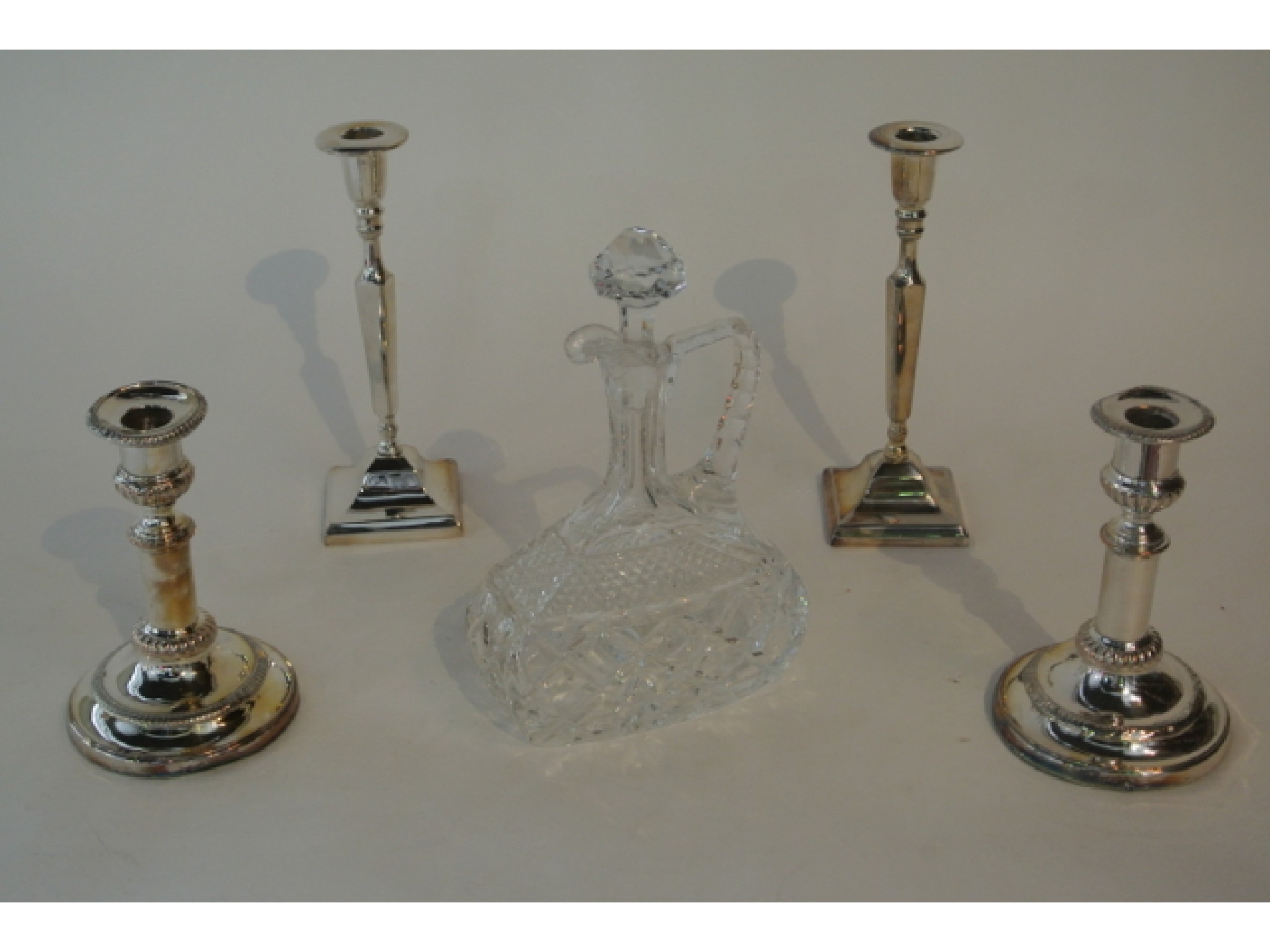 Appraisal: Two pairs of silver plated candlesticks together with a clear