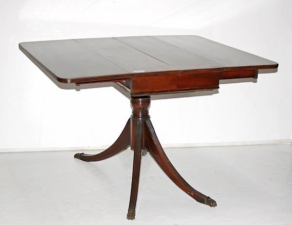 Appraisal: A Regency style mahogany dining table with two leaves