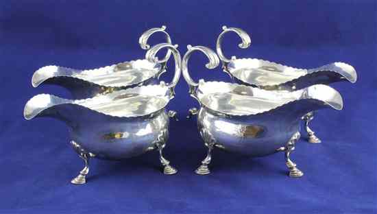 Appraisal: A set of four George III silver sauceboats with cusped